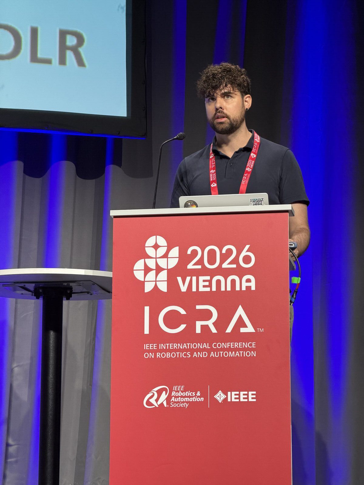 Markus Knauer giving the Next-Gen Spotlight Award presentations at the ICRA 2026 workshop in Vienna