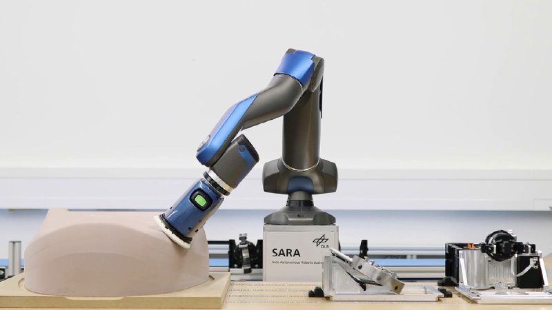 Close-up of SARA robot arm performing the bearing ring measurement task at the trade fair